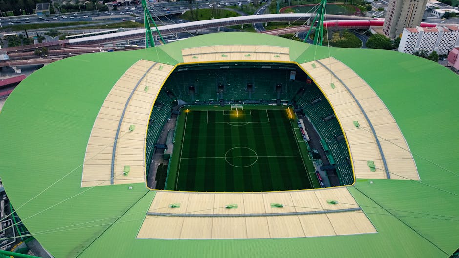 modern soccer stadium aerial view with green pitch and seating